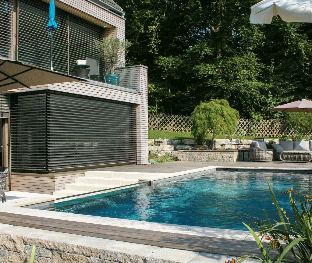 Pool beside the house with natural stone edging and steps in Villingen-Schwenningen