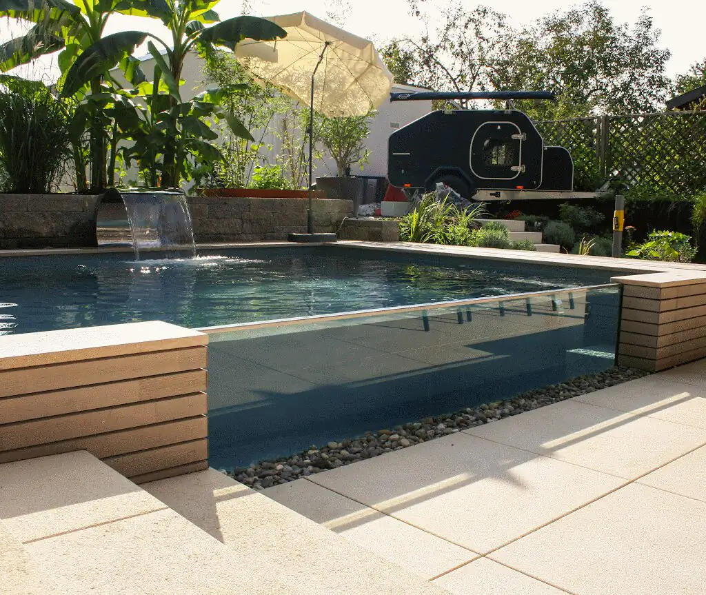 Pool with glass wall and waterfall in the middle of the garden in Villingen-Schwenningen