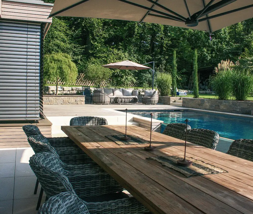 Dining table overlooking the pool and lounge in Villingen-Schwenningen