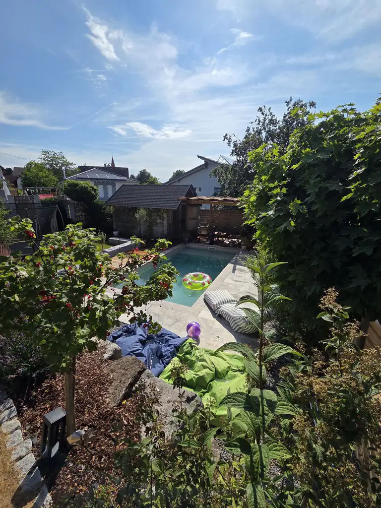 Garden pool with pergola and timber deck among plants, seen from above in Villingen-Schwenningen