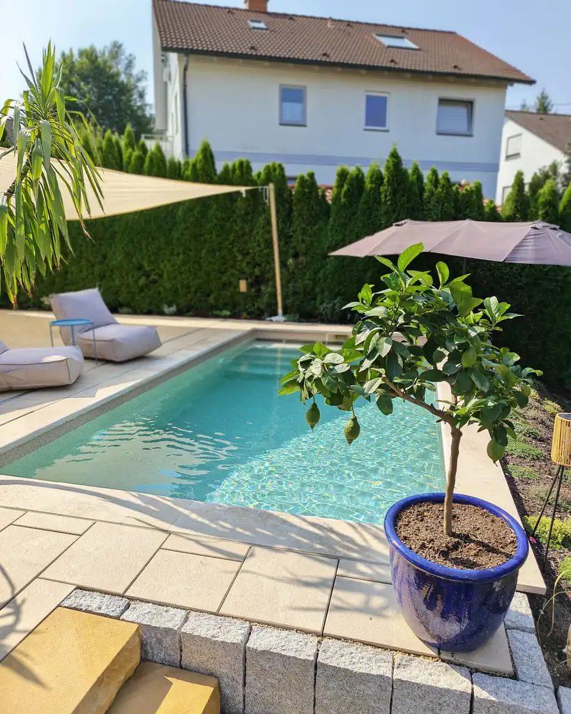 Sandstone terrace by the pool with shade sail in Villingen-Schwenningen