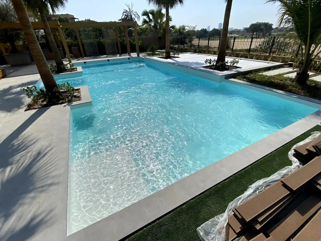 Infinity edge of the resort pool under palms in Dubai